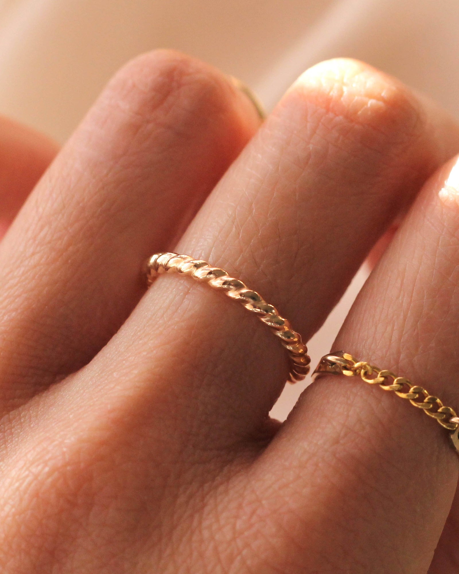 Sample B1 Thick Twist Ring, 14K gold filled, on white textured surface
